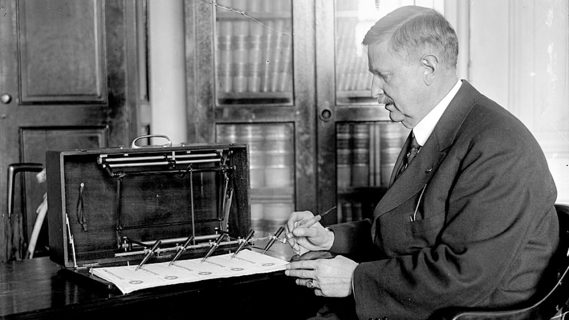 Black and white photo of man demonstrating the autopen
