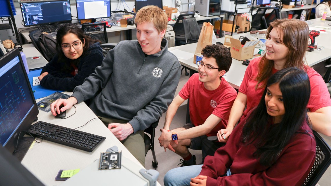 Group of students in front of computer screen