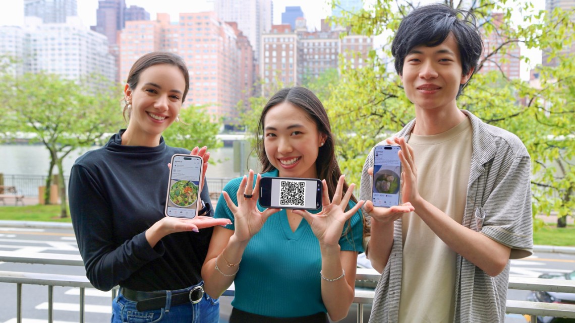 Provided Alexandra Taic M.B.A. '25 (left), Selina Li ’25 and Zach Zhong ’25, all principals of Gymii.ai, a new nutrition tracking app, hold up the app and a recent QR code.