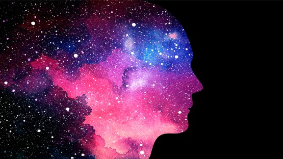 A color photo showing a silhouette of a face with outer space clouds in the bg. Shutterstock
