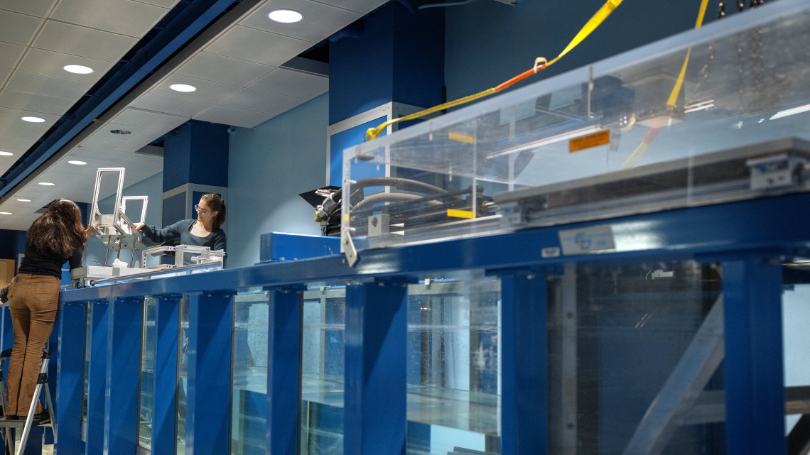 Ryan Young/Cornell University Kavya Mittha ’26, left, and Aisha Brundan ’25, working for Prof. Maha Haji, test their bobbing buoy wave energy converter at the DeFrees Hydraulics Lab in Hollister Hall.