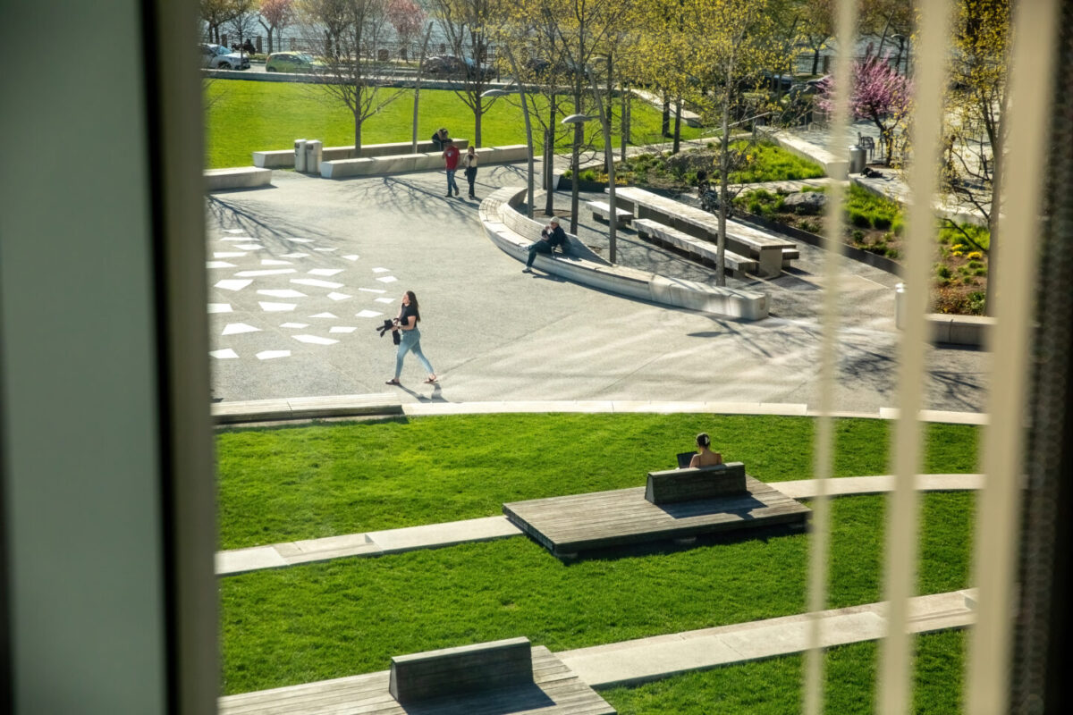 view our window of Cornell Tech's campus, shows people walking on paths