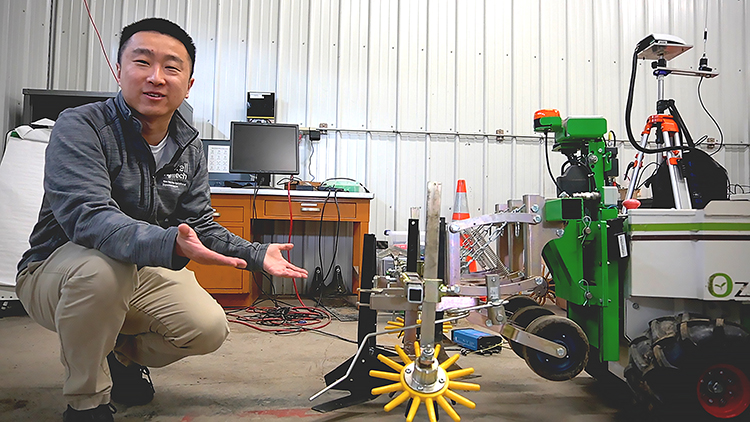 Man kneeling and showing off robot