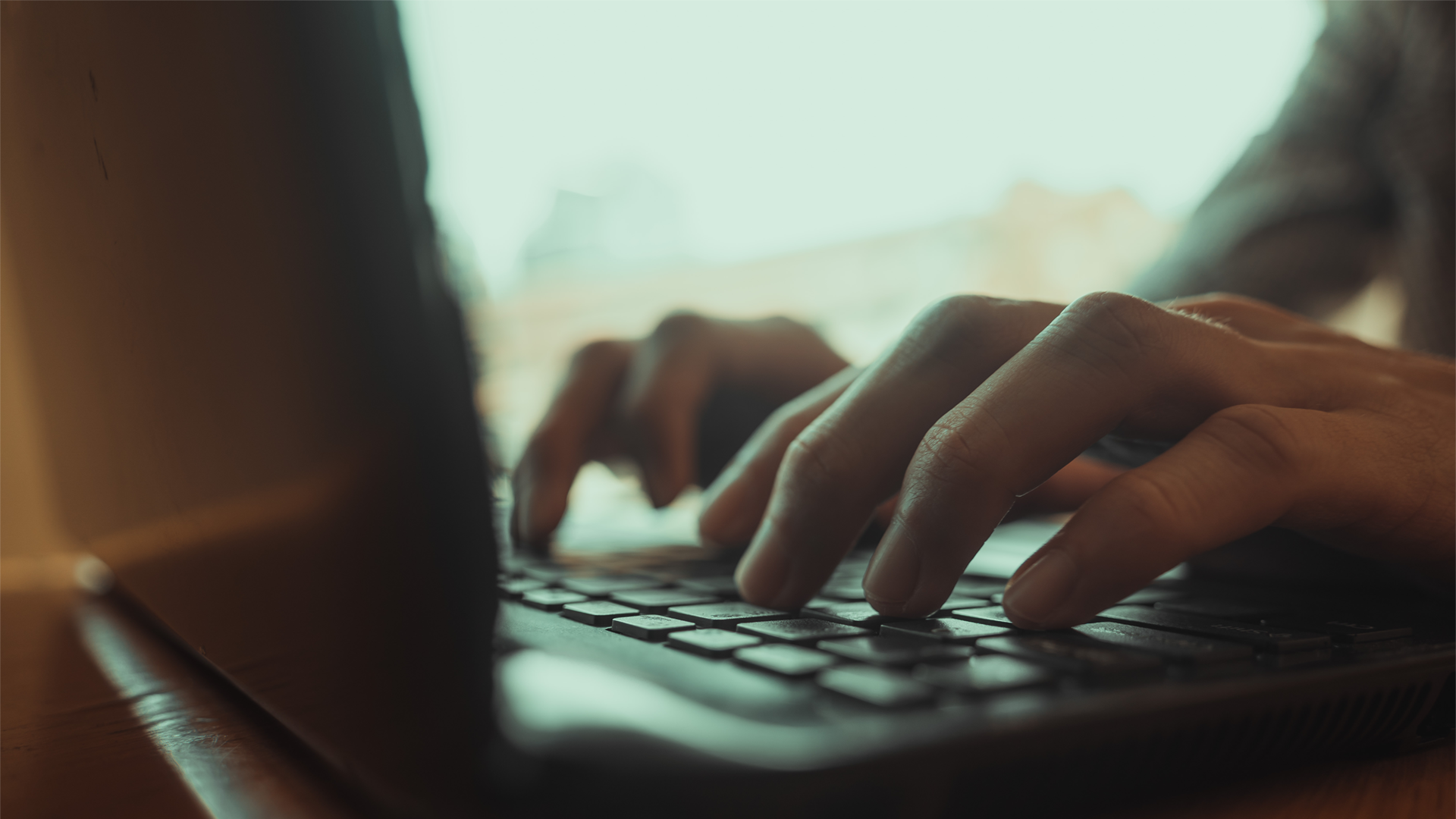 Close focus of man's hands typing Credit: Shutterstock