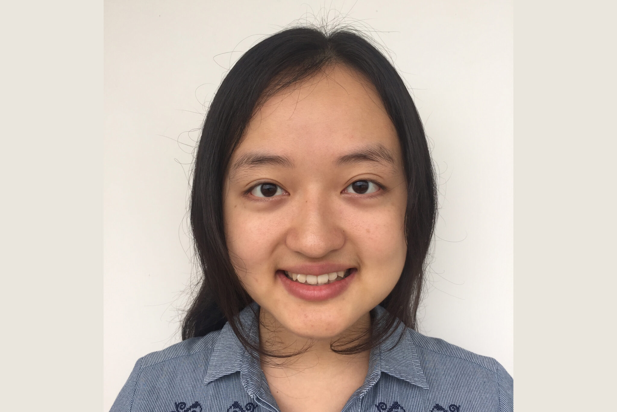 A color photo of a woman smiling for a photo