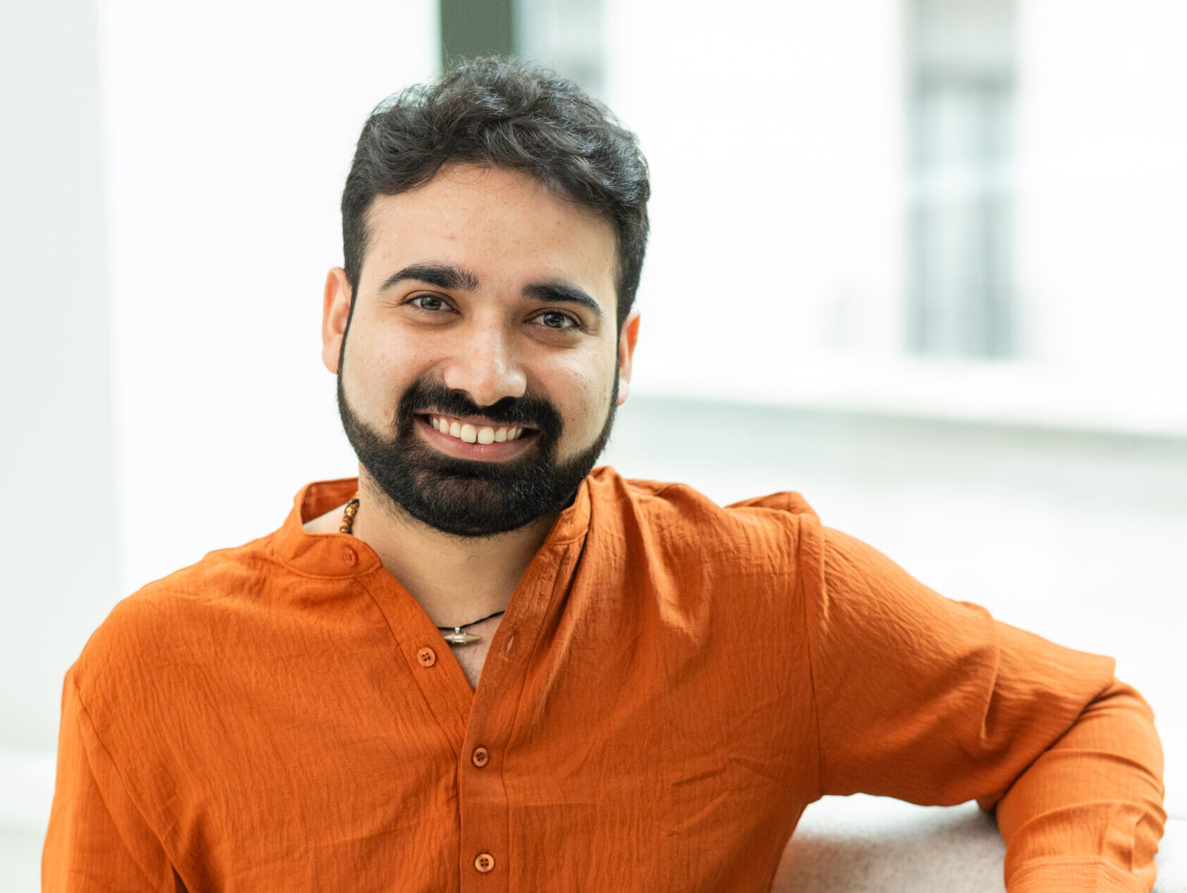 A color photo of a man smiling for a photo