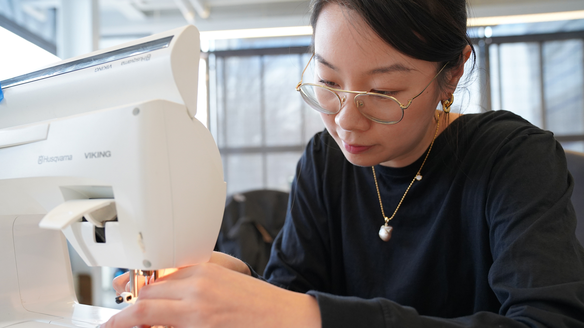 Louis DiPietro/Provided Catherine Yu creates smart clothing by sewing conductive threads into the seams of a normal T-shirt in the Sci-Fi Lab.