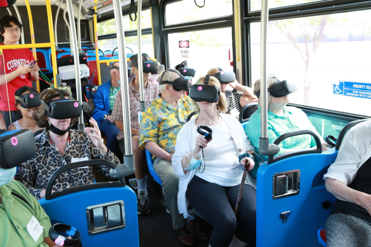 People on bus wearing VR headsets