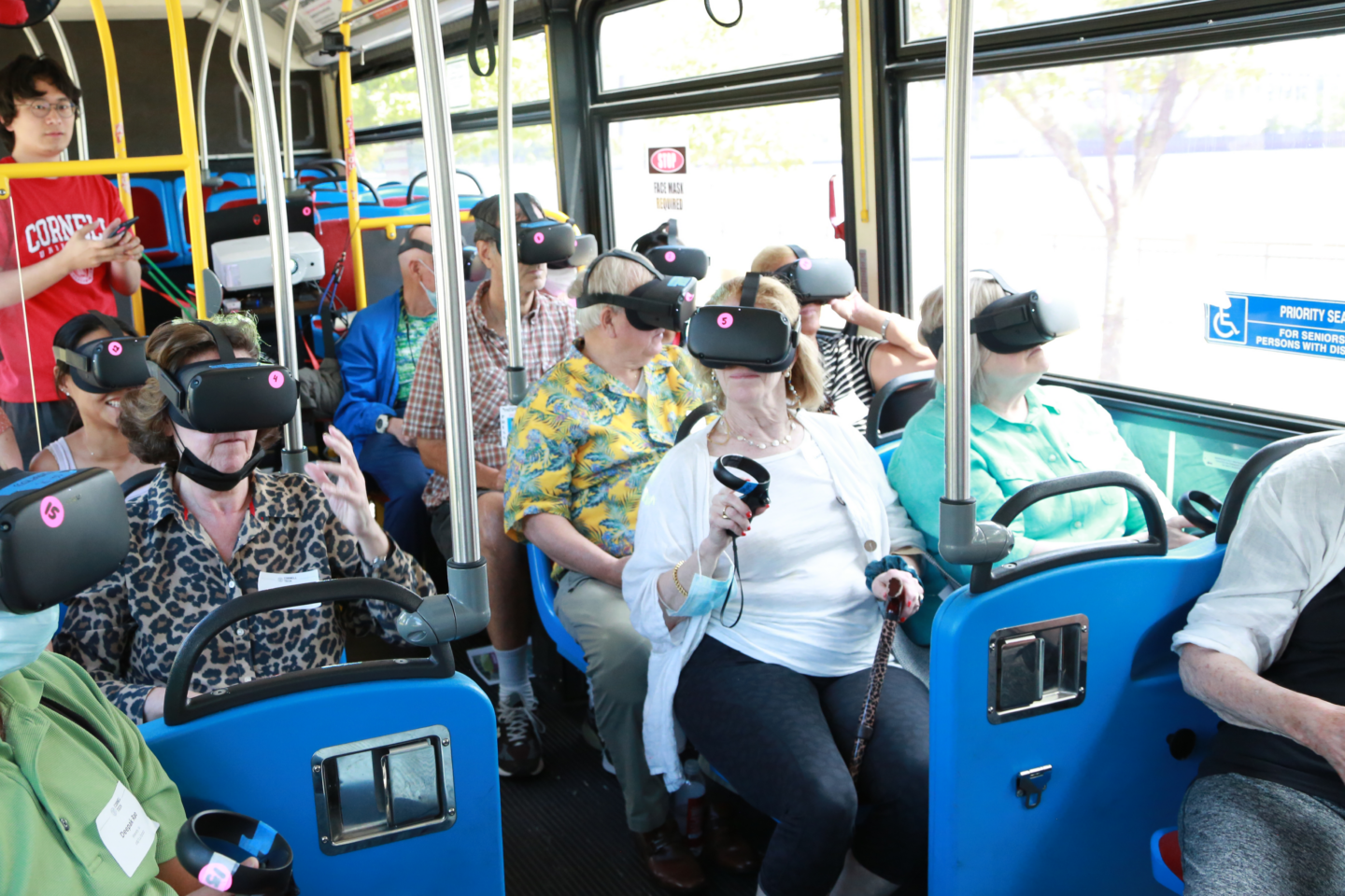 People on bus wearing VR headsets