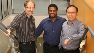 Three founders standing on the stairs