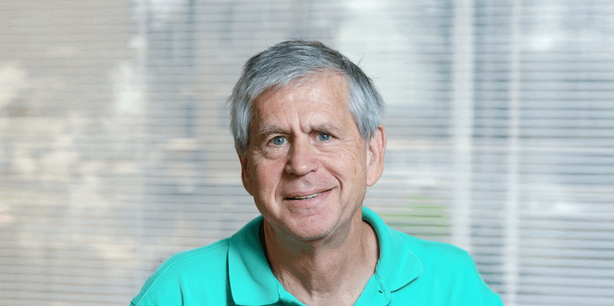 Portrait of Michael Macy in a teal shirt.