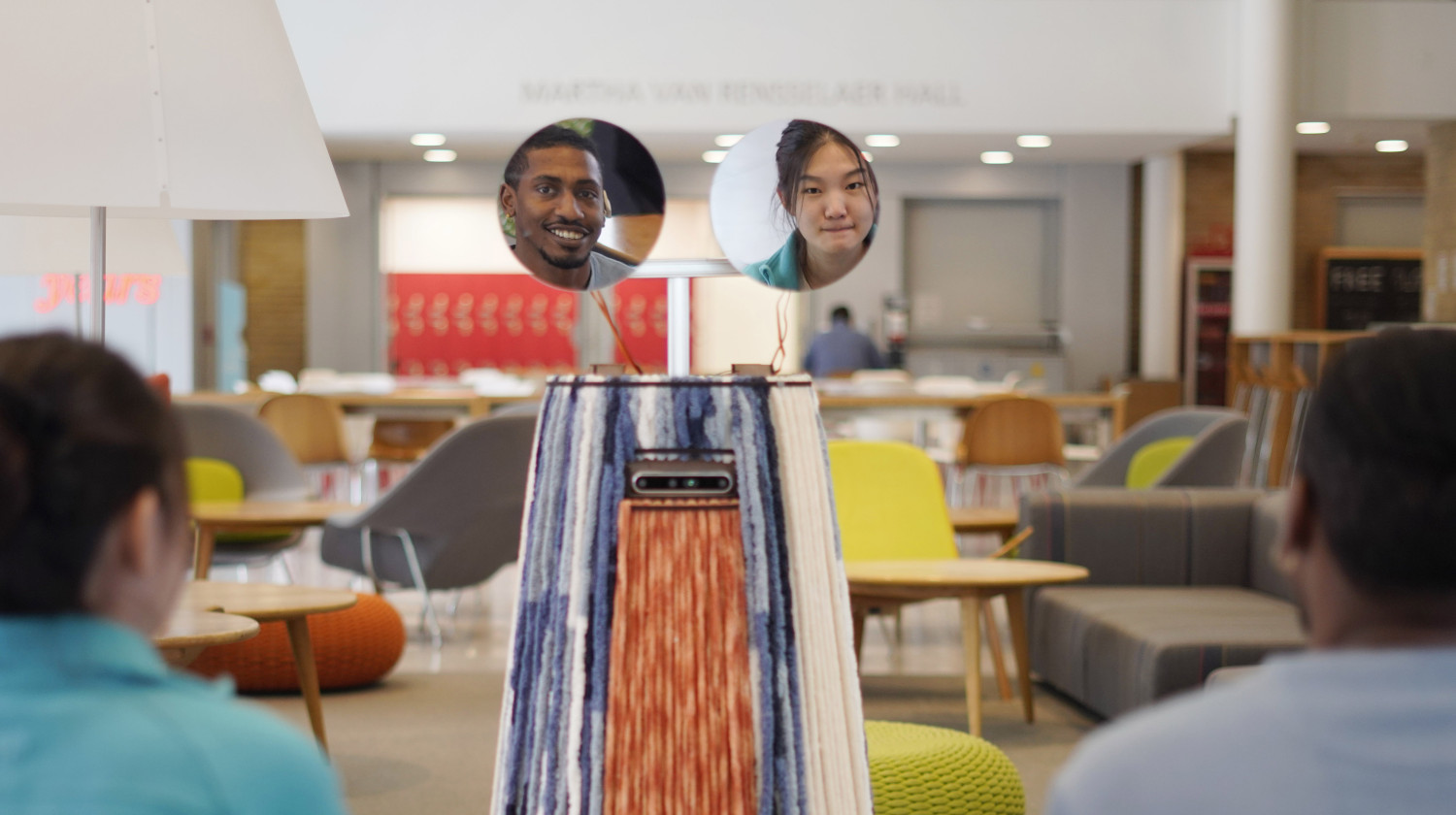 Reflection of researchers in mirrors held by Robot