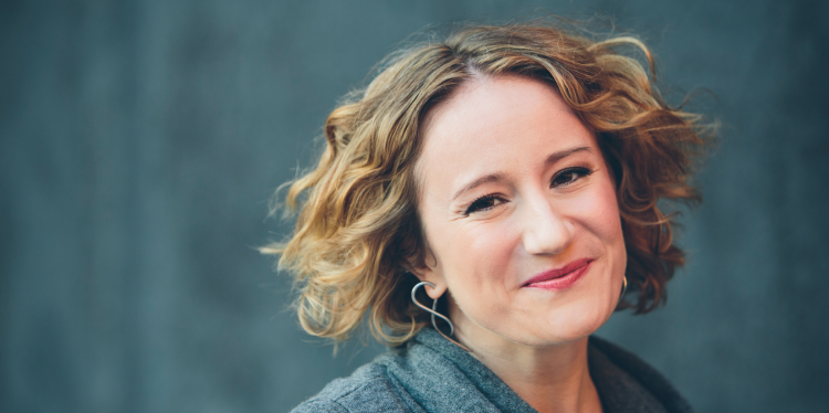 A color photo of a woman smiling for a photo