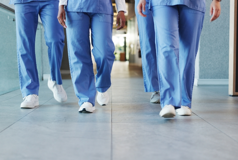 shutterstock_2713351969 Feet of people wearing scrubs